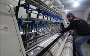 A Syrian refugee at work in a Lebanese textile factory supported by UK aid and Mercy Corps.png