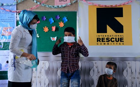 An IRC hygiene promotor provides training and critical information about Covid-19 to women, men and children in Herat province, Afghanistan.jpg