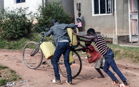 Fetching water for home and agricultural use. Mpigi, Uganda.jpg